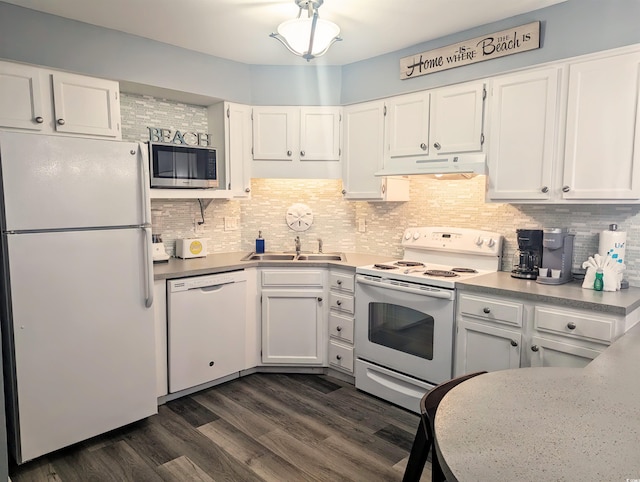 kitchen with white cabinetry, white appliances, under cabinet range hood, and a sink