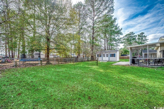 view of yard featuring a storage shed and a patio