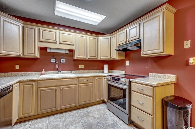 kitchen featuring light tile patterned flooring, stainless steel appliances, and sink