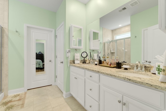 bathroom featuring tile patterned floors, vanity, and an enclosed shower