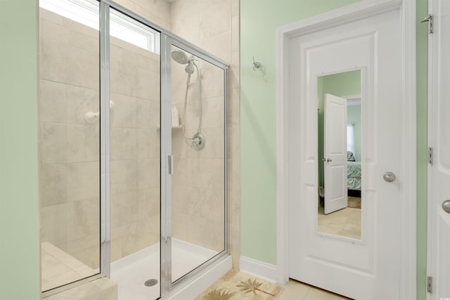 bathroom with tile patterned floors and walk in shower