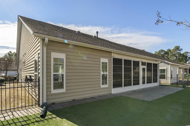 rear view of house featuring a patio area and a lawn