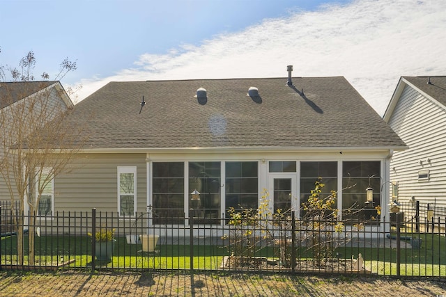 rear view of property with a sunroom and a yard