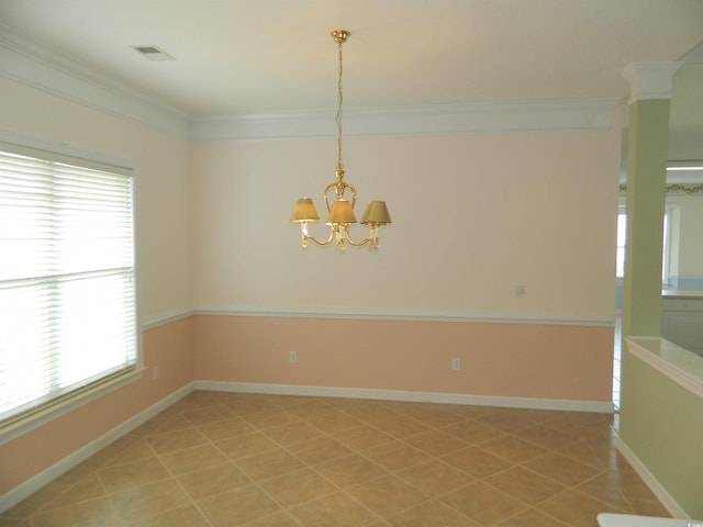 empty room with tile patterned floors, ornamental molding, and a notable chandelier