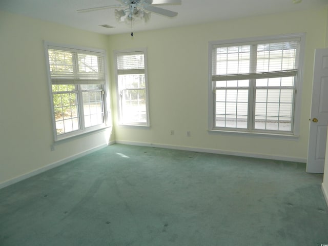 empty room featuring carpet flooring and ceiling fan