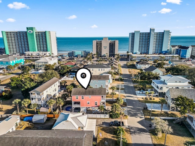 drone / aerial view featuring a view of city and a water view