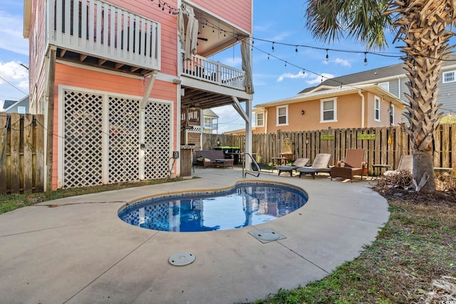 view of swimming pool featuring a patio area and fence