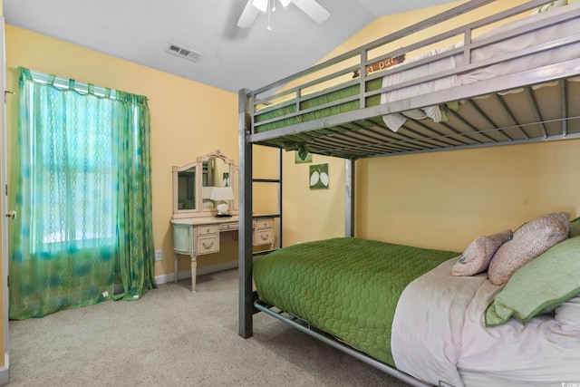 carpeted bedroom with visible vents, vaulted ceiling, and ceiling fan