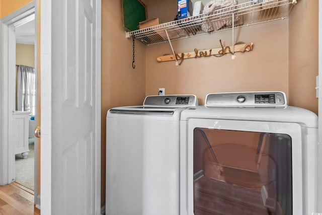 laundry area featuring laundry area, wood finished floors, and independent washer and dryer