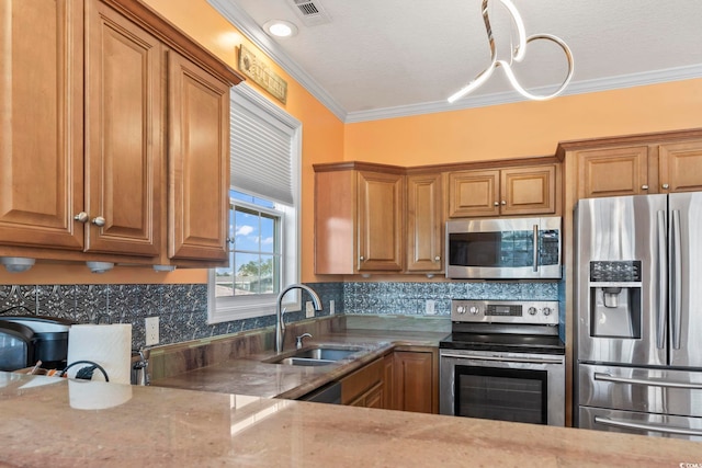 kitchen featuring crown molding, visible vents, appliances with stainless steel finishes, brown cabinetry, and a sink