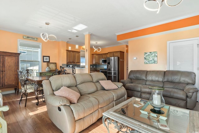 living area featuring ornamental molding and wood finished floors