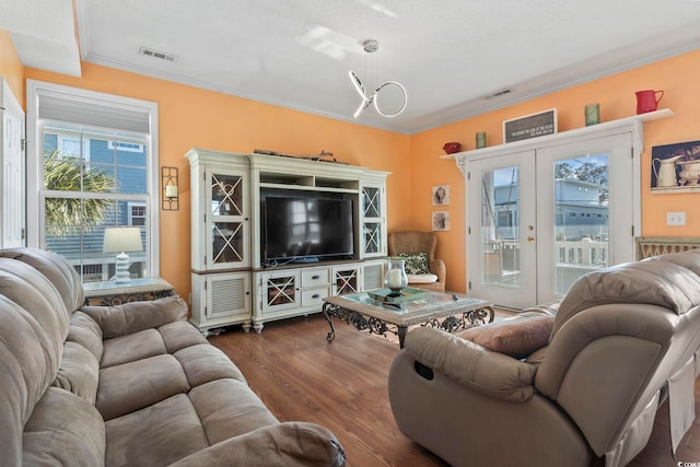 living room featuring dark wood-style floors, french doors, visible vents, and crown molding