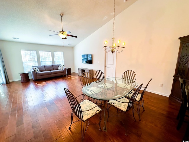 dining room with high vaulted ceiling, dark hardwood / wood-style flooring, and ceiling fan with notable chandelier