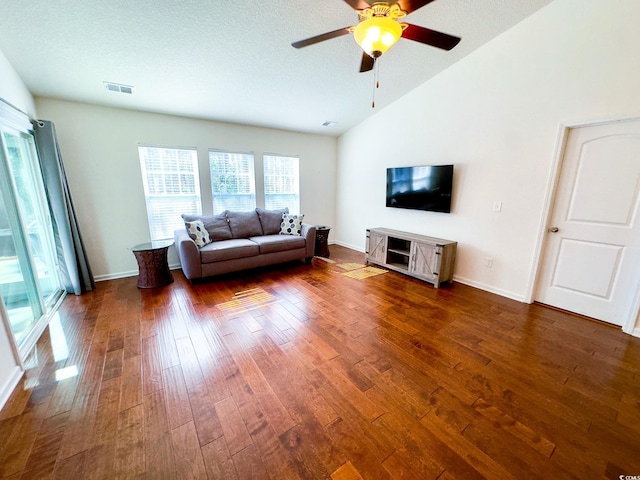 unfurnished living room with lofted ceiling, dark hardwood / wood-style floors, and ceiling fan