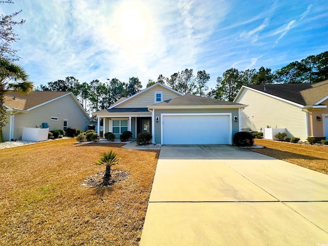 view of front of property with a garage and a front lawn