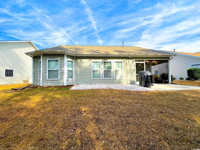 back of property featuring a yard and a patio