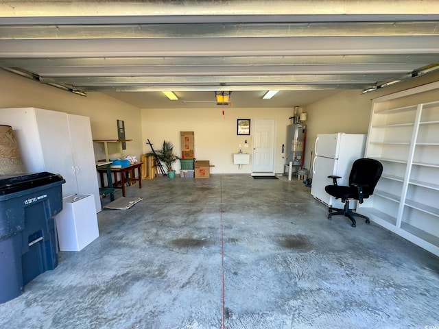 garage with water heater, a garage door opener, sink, and white fridge