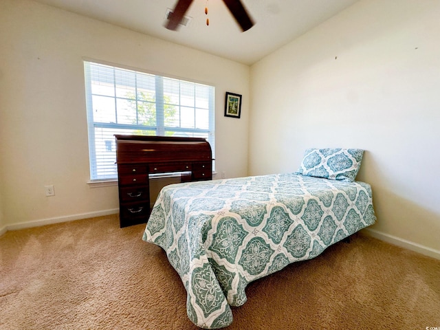 bedroom featuring multiple windows, vaulted ceiling, ceiling fan, and carpet