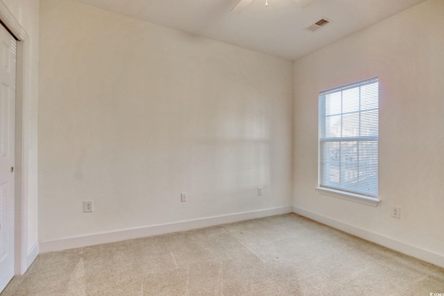 spare room with light carpet and ceiling fan