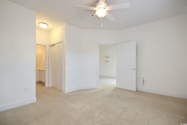 empty room with ceiling fan and light colored carpet