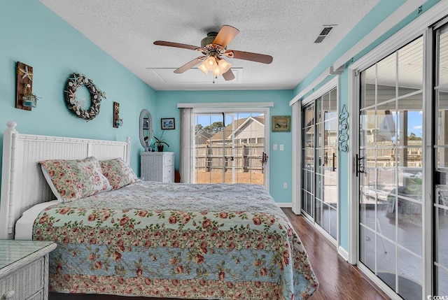 bedroom with ceiling fan, dark wood-type flooring, access to outside, and a textured ceiling