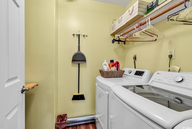 laundry area with dark wood-type flooring and independent washer and dryer