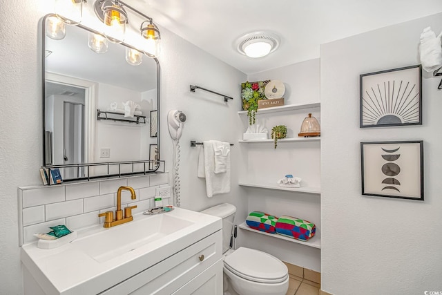 bathroom featuring vanity, toilet, and decorative backsplash