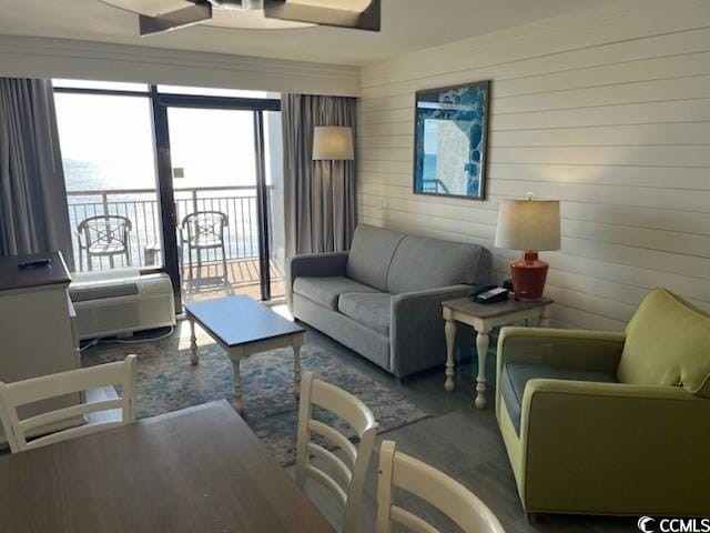 living area with a ceiling fan and wood finished floors