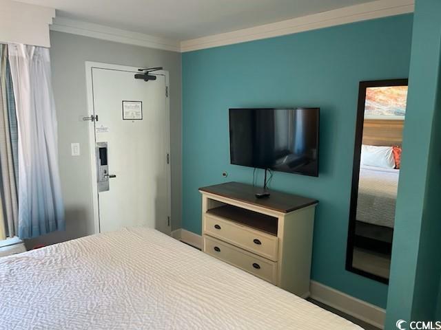 bedroom featuring ornamental molding and baseboards