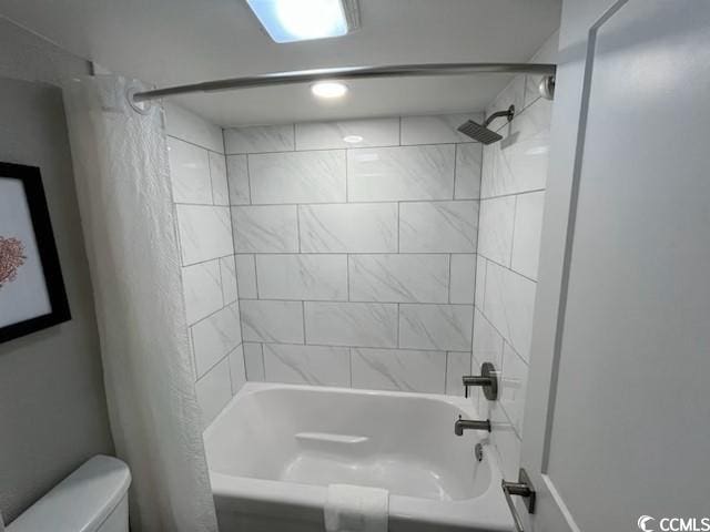 full bathroom featuring toilet and shower / bath combination with curtain