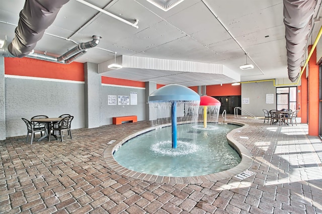 community pool featuring an indoor hot tub