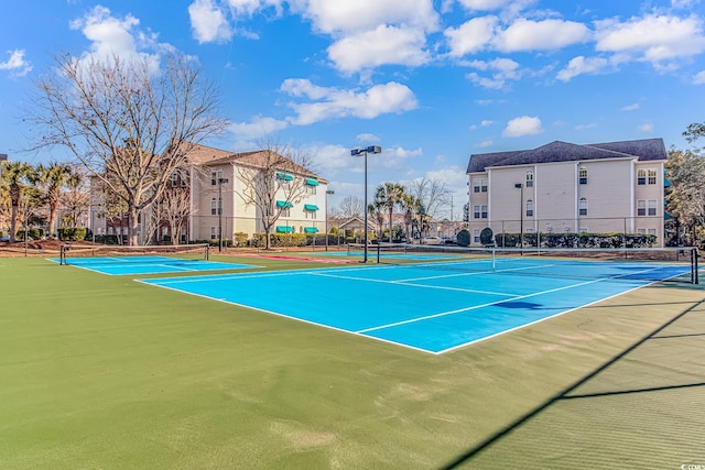 view of tennis court featuring fence