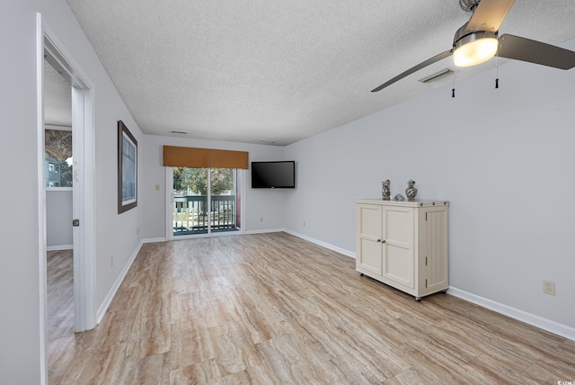 unfurnished living room with ceiling fan, light hardwood / wood-style floors, and a textured ceiling