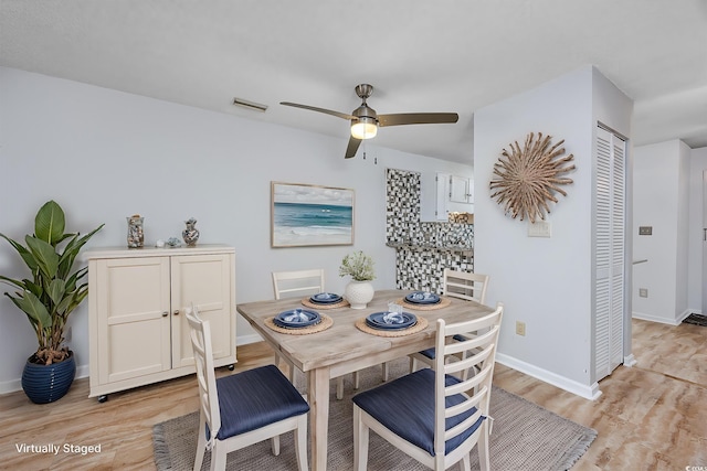 dining space with ceiling fan and light hardwood / wood-style floors