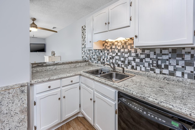 kitchen featuring sink, white cabinetry, a textured ceiling, dishwasher, and ceiling fan