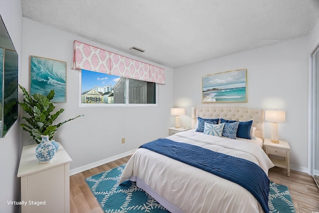 bedroom with wood-type flooring