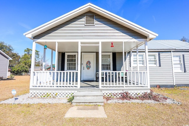 view of front of property with a front yard and a porch