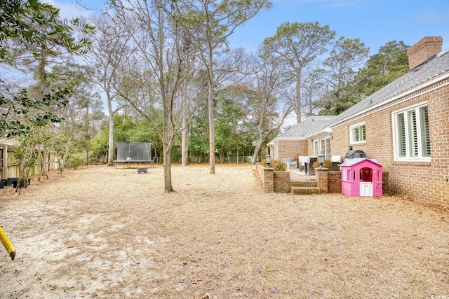 view of yard with a trampoline