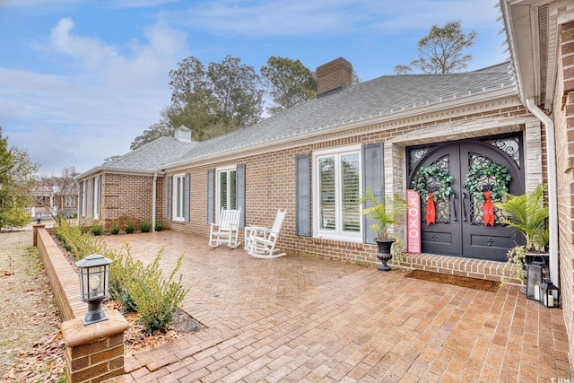 rear view of property with a patio area and french doors