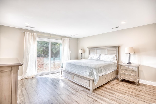 bedroom with access to exterior and light wood-type flooring