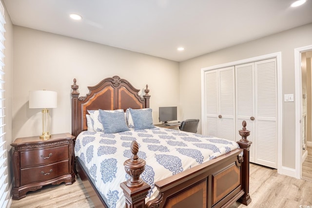 bedroom with light hardwood / wood-style flooring and a closet