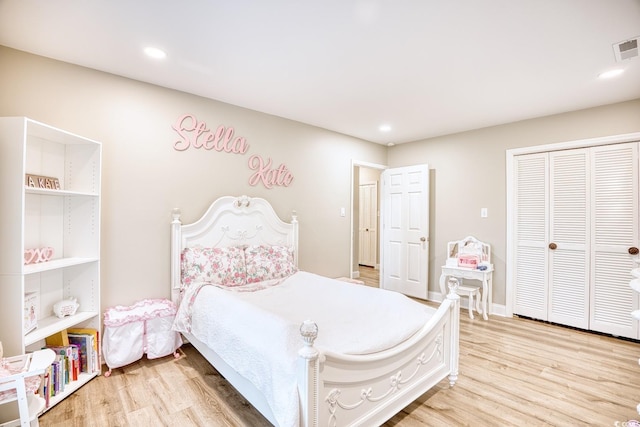 bedroom featuring light hardwood / wood-style floors and a closet