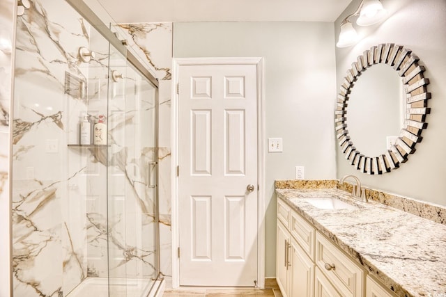 bathroom with vanity, wood-type flooring, and walk in shower