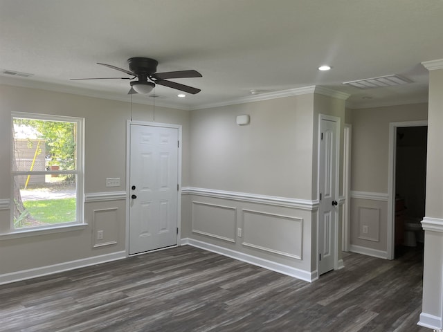 empty room with crown molding, dark hardwood / wood-style floors, and ceiling fan