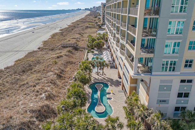 birds eye view of property with a view of the beach and a water view