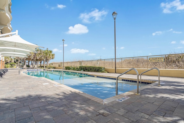 view of swimming pool featuring a patio area