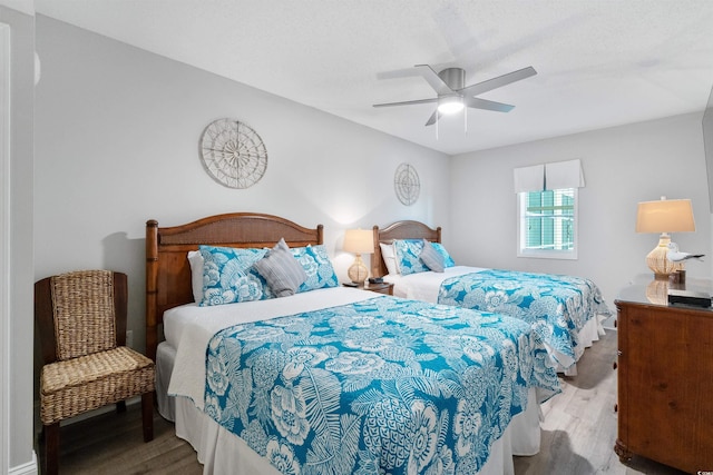 bedroom with wood-type flooring and ceiling fan