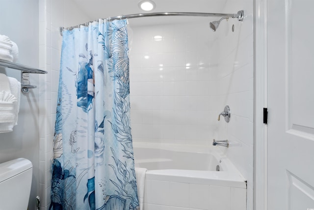 bathroom with shower / tub combo with curtain and toilet