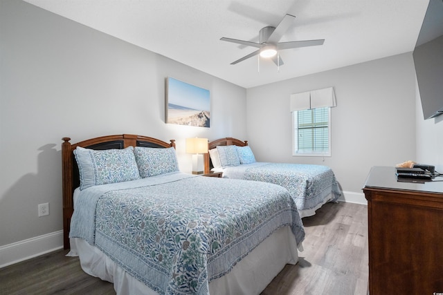 bedroom with wood-type flooring and ceiling fan