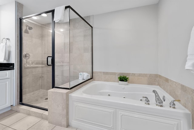 bathroom featuring vanity, tile patterned floors, and plus walk in shower